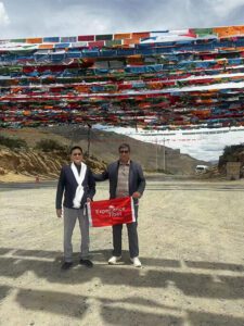 tourists with colorful prayer flags in tibet