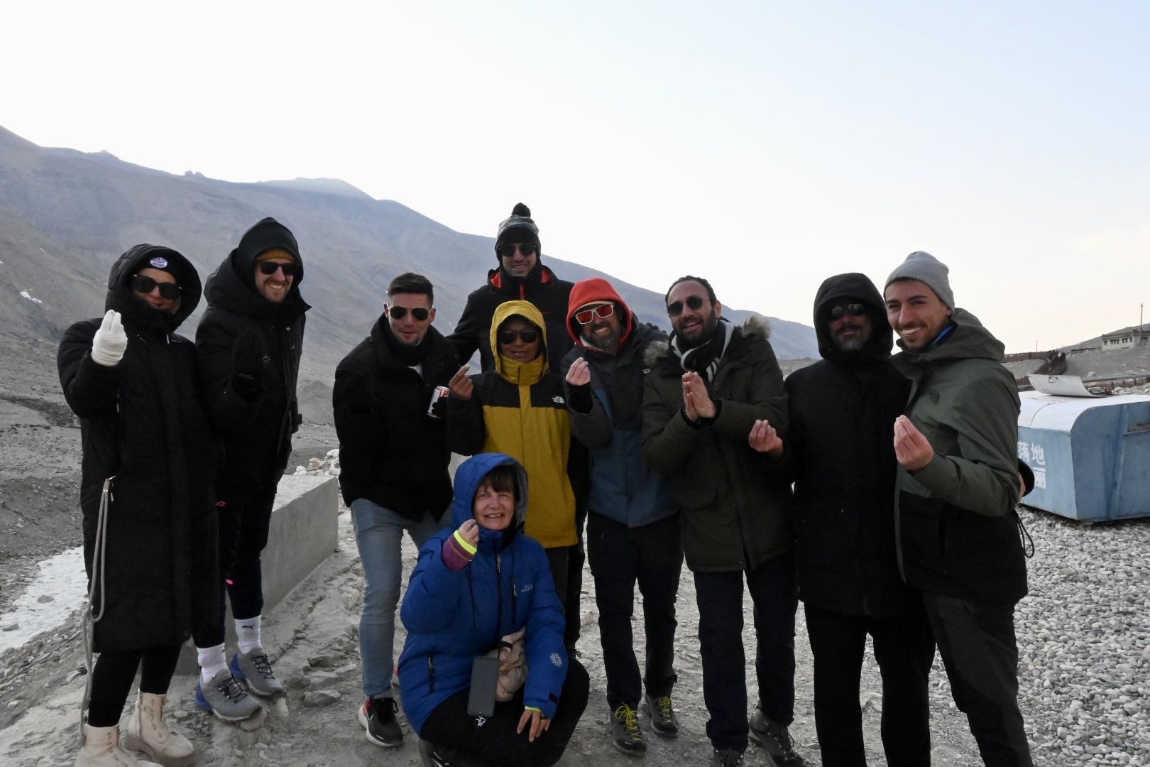 Solo Travelers Group at Everest Base Camp - Tibet Group Tour Solo travelers group posing together at Everest Base Camp 5200m high altitude Tibet adventure