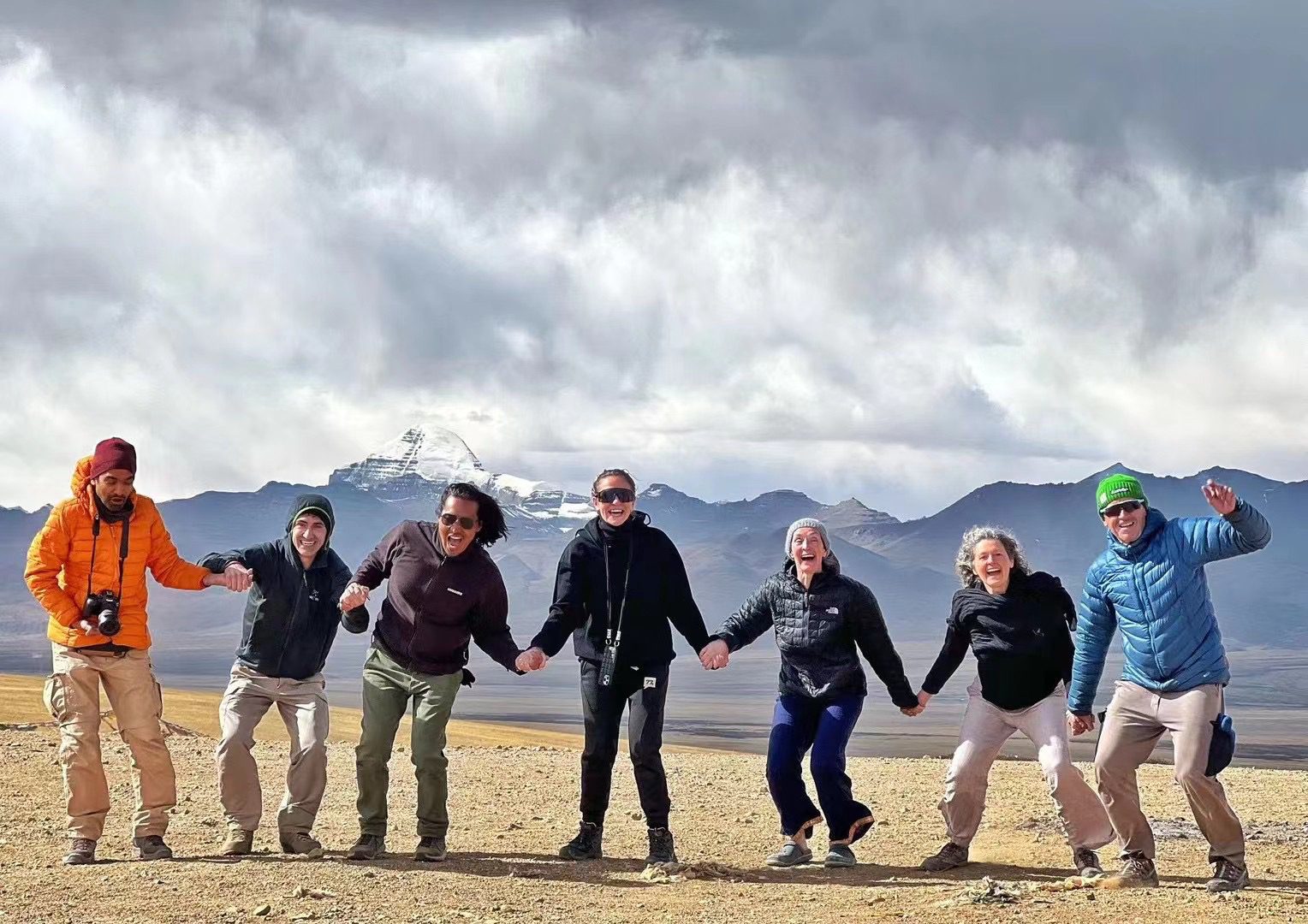 Solo Travelers Winter Adventure with Snowy Himalayan Peaks Solo travelers winter adventure group bundled in gear with snowy Himalayan peaks backdrop