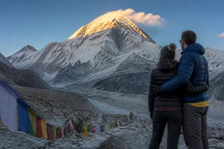 Couple embracing at Everest North Base Camp at sunrise during a Himalayan honeymoon tour, Tibet