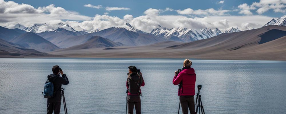 photographers-capturing-mountain-views-by-lake-in-tibet