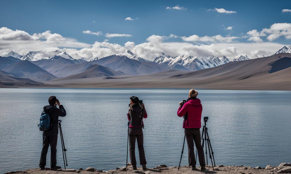 photographers-capturing-mountain-views-by-lake-in-tibet